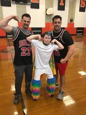 two gym teachers posing with a student 